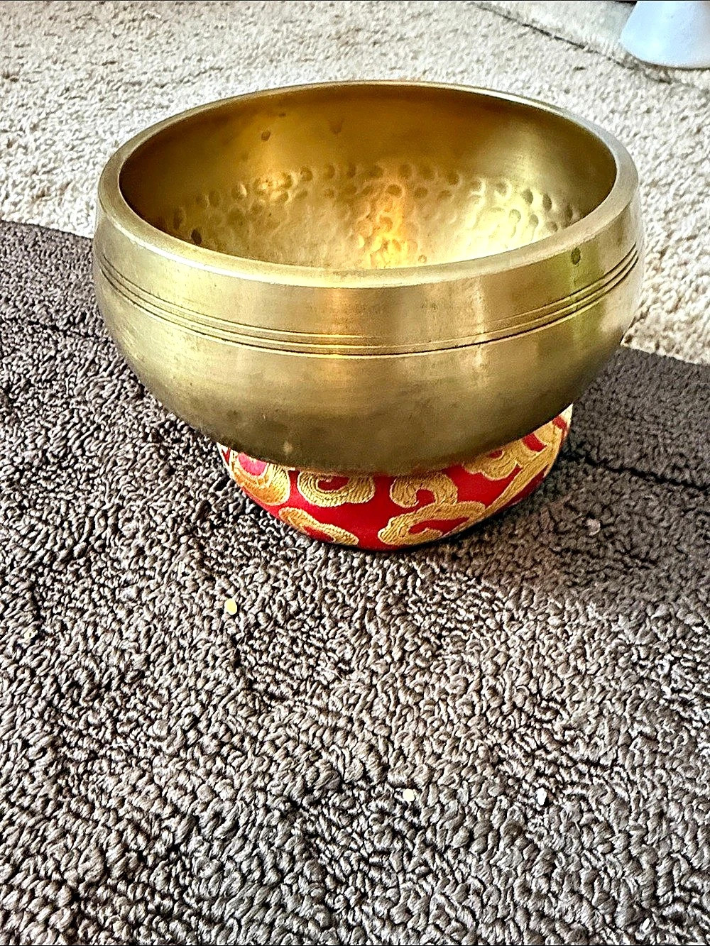 Brass Singing Bowl with Cushion in Gold & Red the bowl has a few water stains